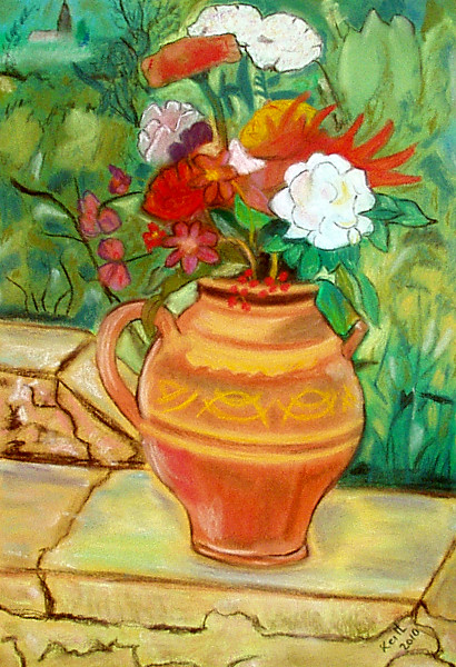 vase and flowers on a low wall
